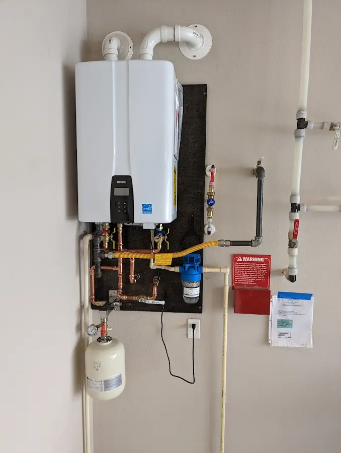 Professional plumber installing copper piping in a Wilkshire Hills home